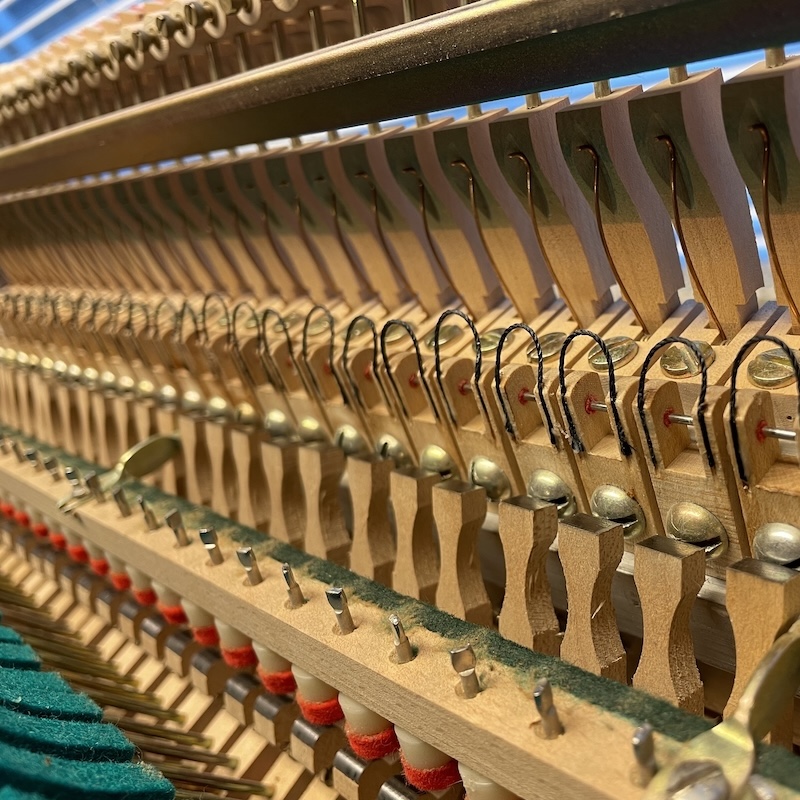 Inside the action of an upright piano
